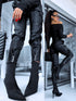 Black faux leather pants with zippers at the ends