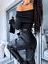 Black faux leather pants with zippers at the ends