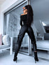 Black faux leather pants with zippers at the ends