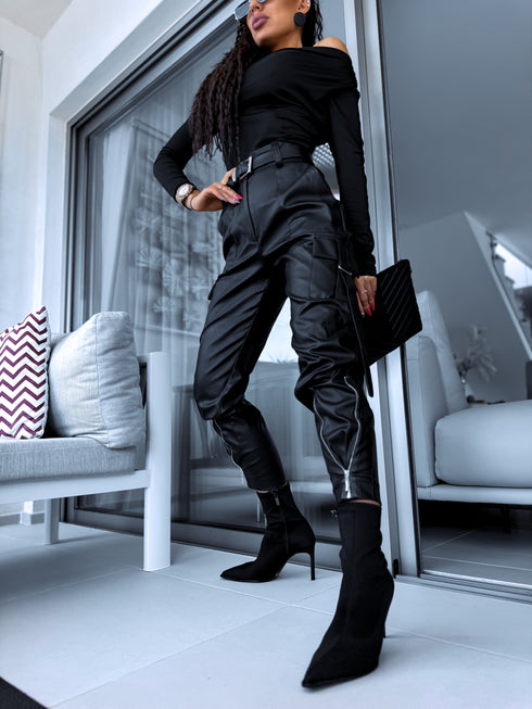 Black faux leather pants with zippers at the ends