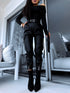 Black faux leather pants with zippers at the ends