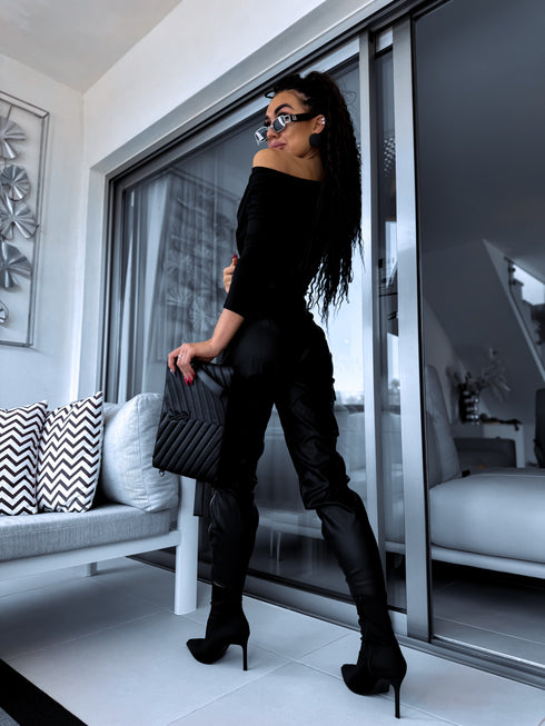 Black faux leather pants with zippers at the ends