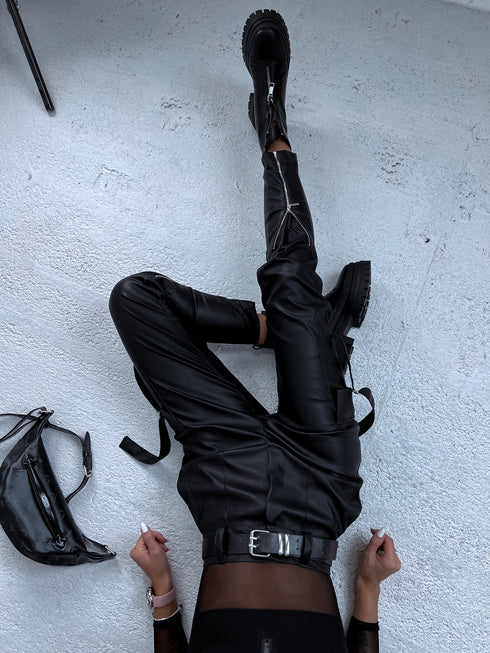 Black faux leather pants with zippers at the ends